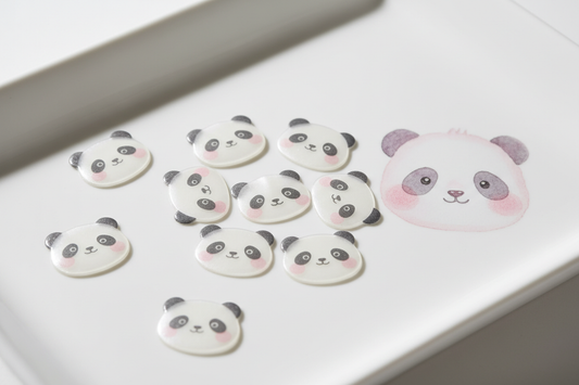 Cute panda-shaped hydrocolloid acne patches arranged on a white surface with soft pastel pink tones